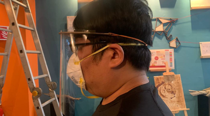 guy with face shield side profike